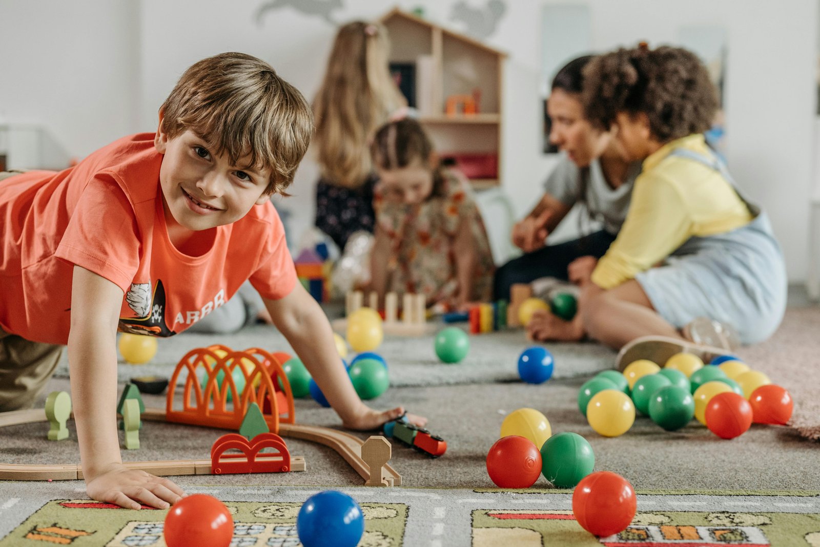 Children playing together in a classroom setting during Gender Identity Lessons.