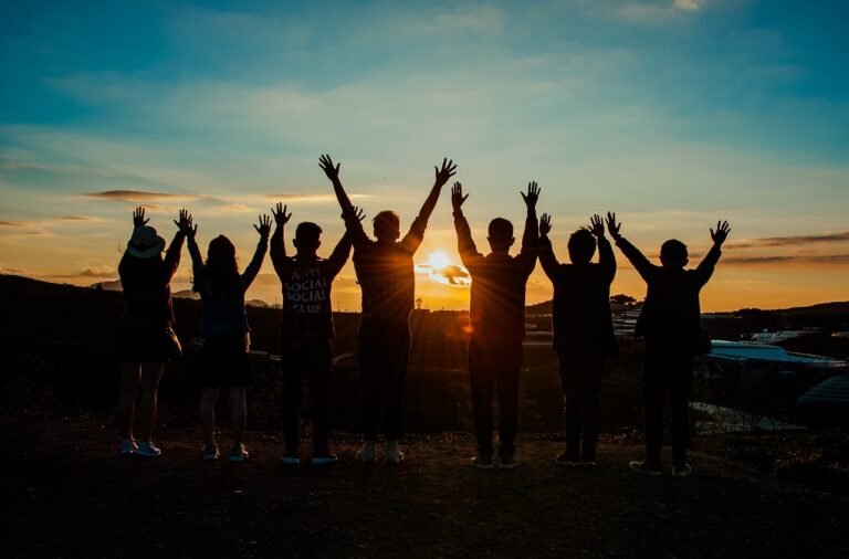 a group of people standing with their hands up - woke political stances