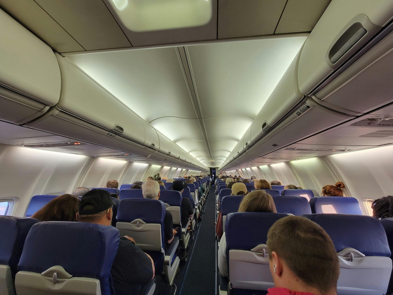 Airline passengers on a flight, relevant to the topic of gender-neutral pronouns on flights.