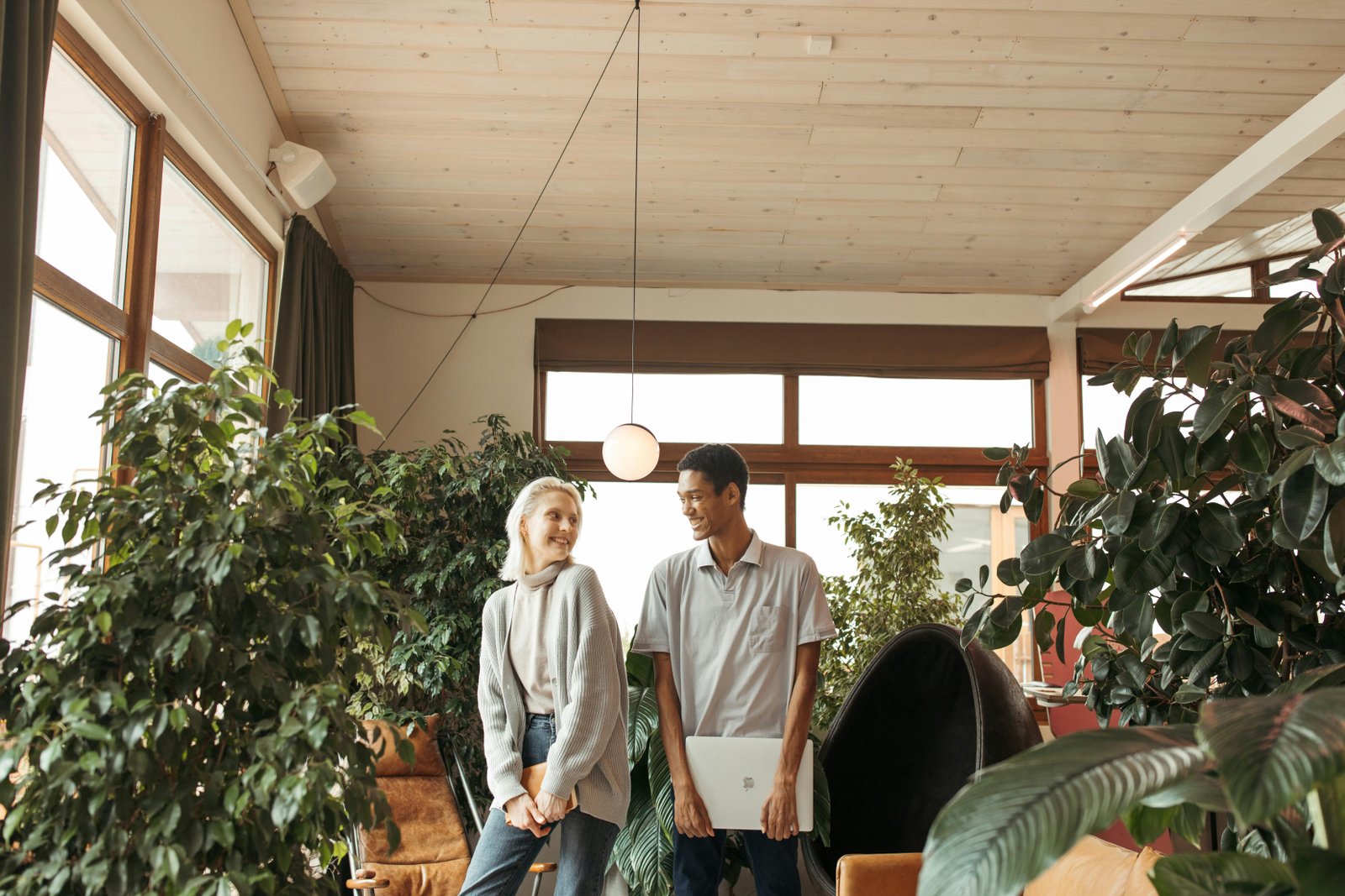 Two people sharing a light moment in a modern indoor space, highlighting respect over conformity.