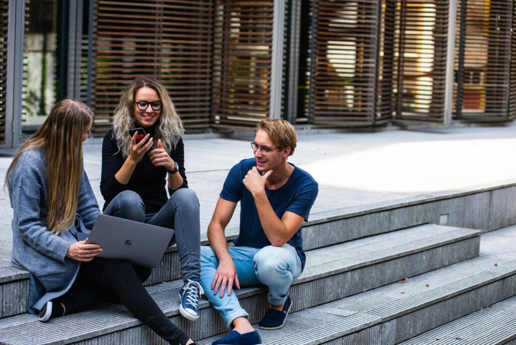 a group of people sitting on steps - Is Freedom of Speech in the Bill of Rights