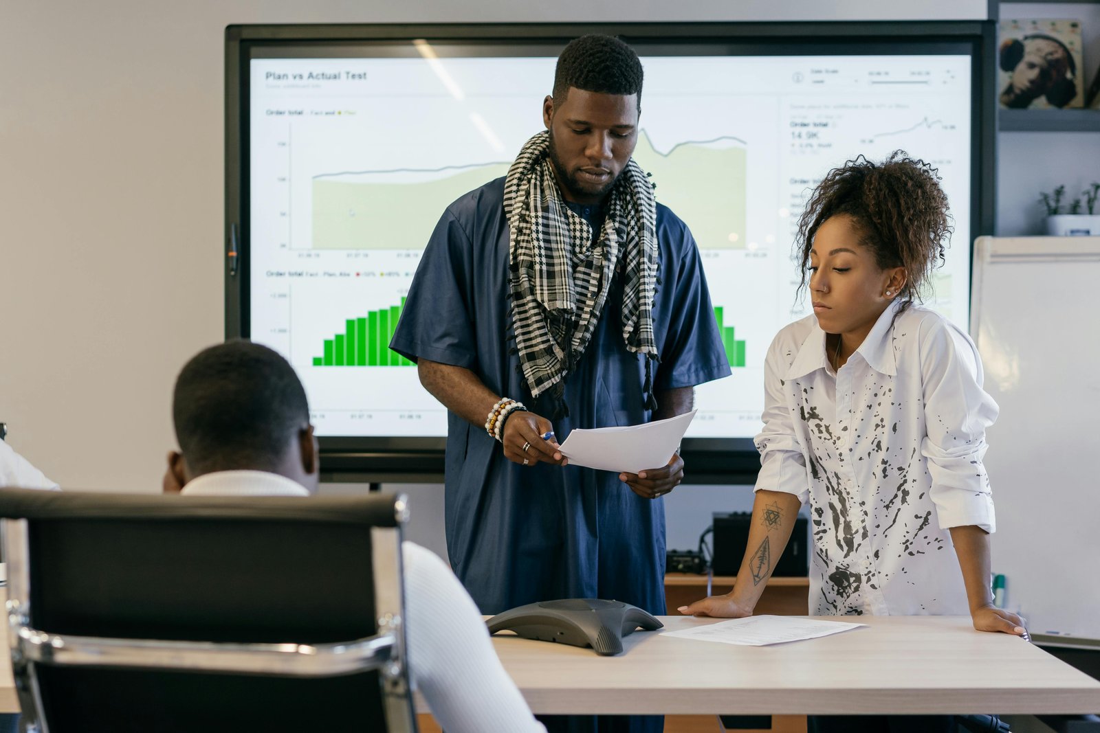 Team reviewing data on Anti-Woke Employment Policies in a business meeting.