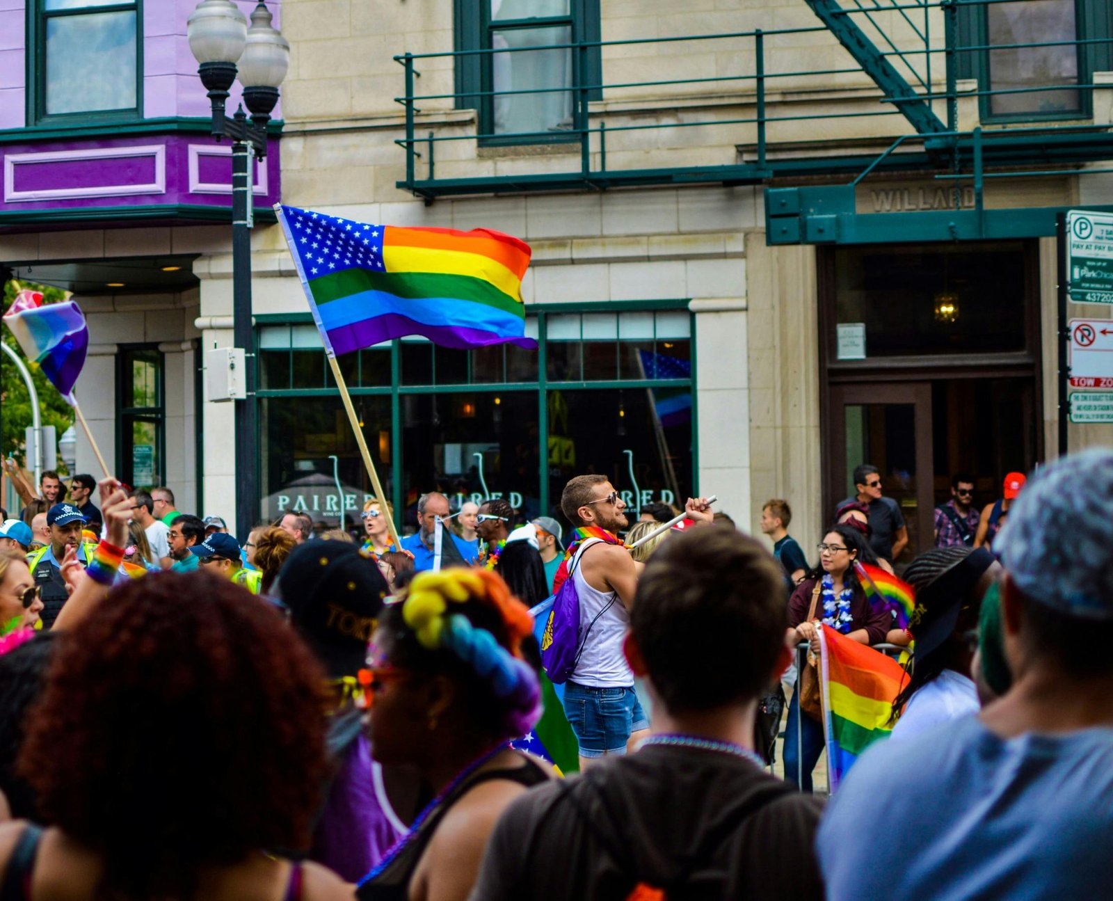 Pride parade with rainbow flags representing the attributes of a woke mind.