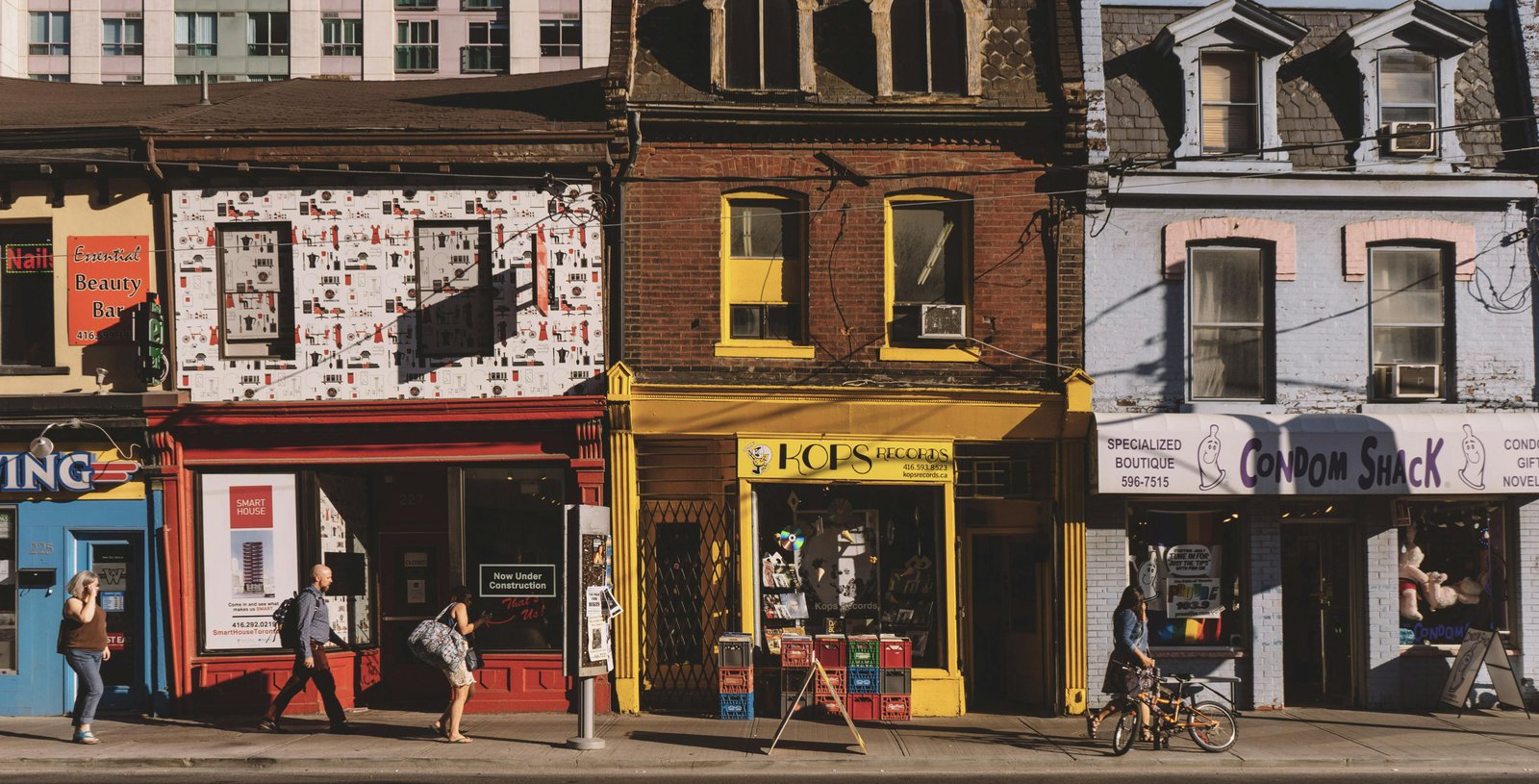 Street view of colorful local shops attracting foot traffic, emphasizing strategies to attract local customers.