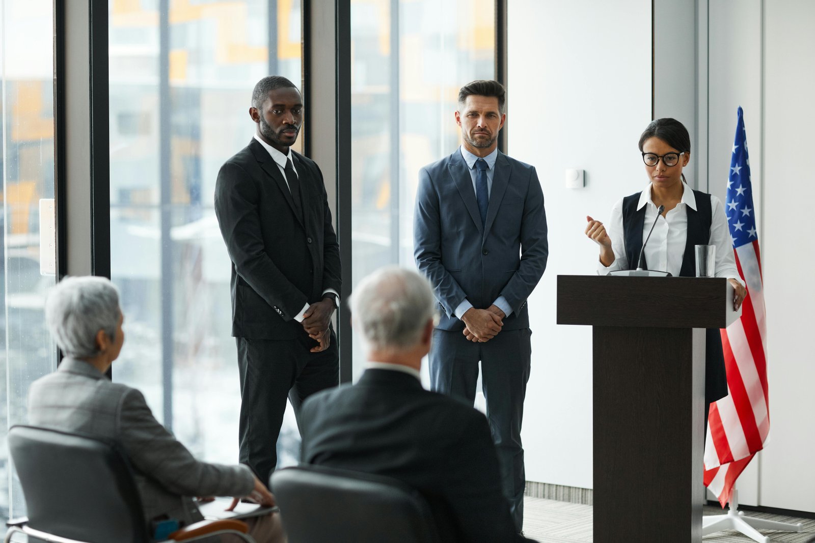 Group of professionals at a press conference discussing the 'Woke vs. Anti-Woke Debate.