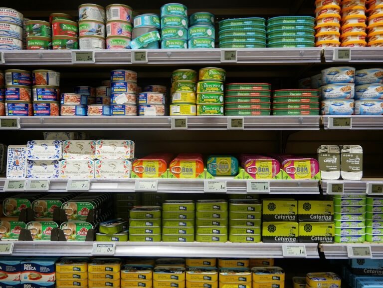 a shelf with different colored cans - laissez-faire economics' role in American history