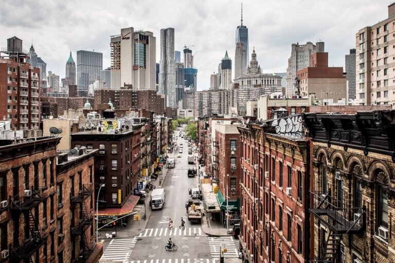 a city street with buildings and a city skyline