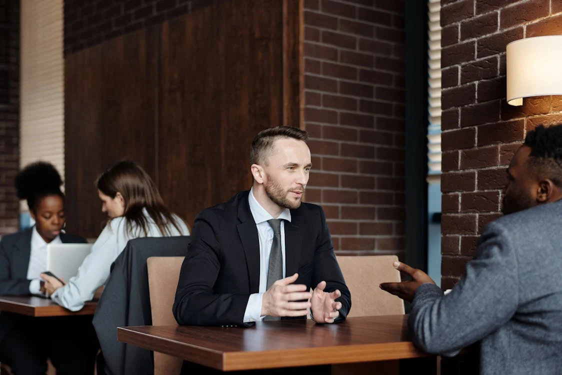 Two professionals discussing strategies, symbolizing an opportunity for business growth.