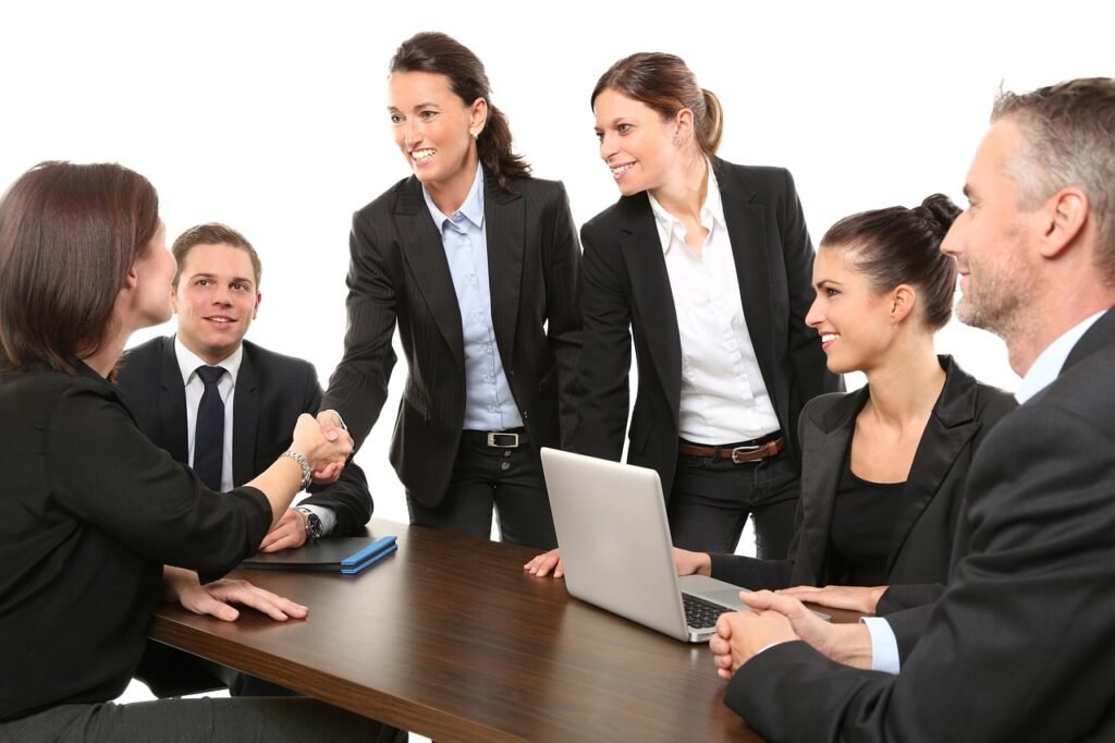 a group of people around a table - good corporate governance