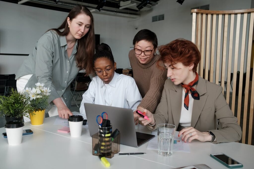 people looking at a laptop - compliance risk management