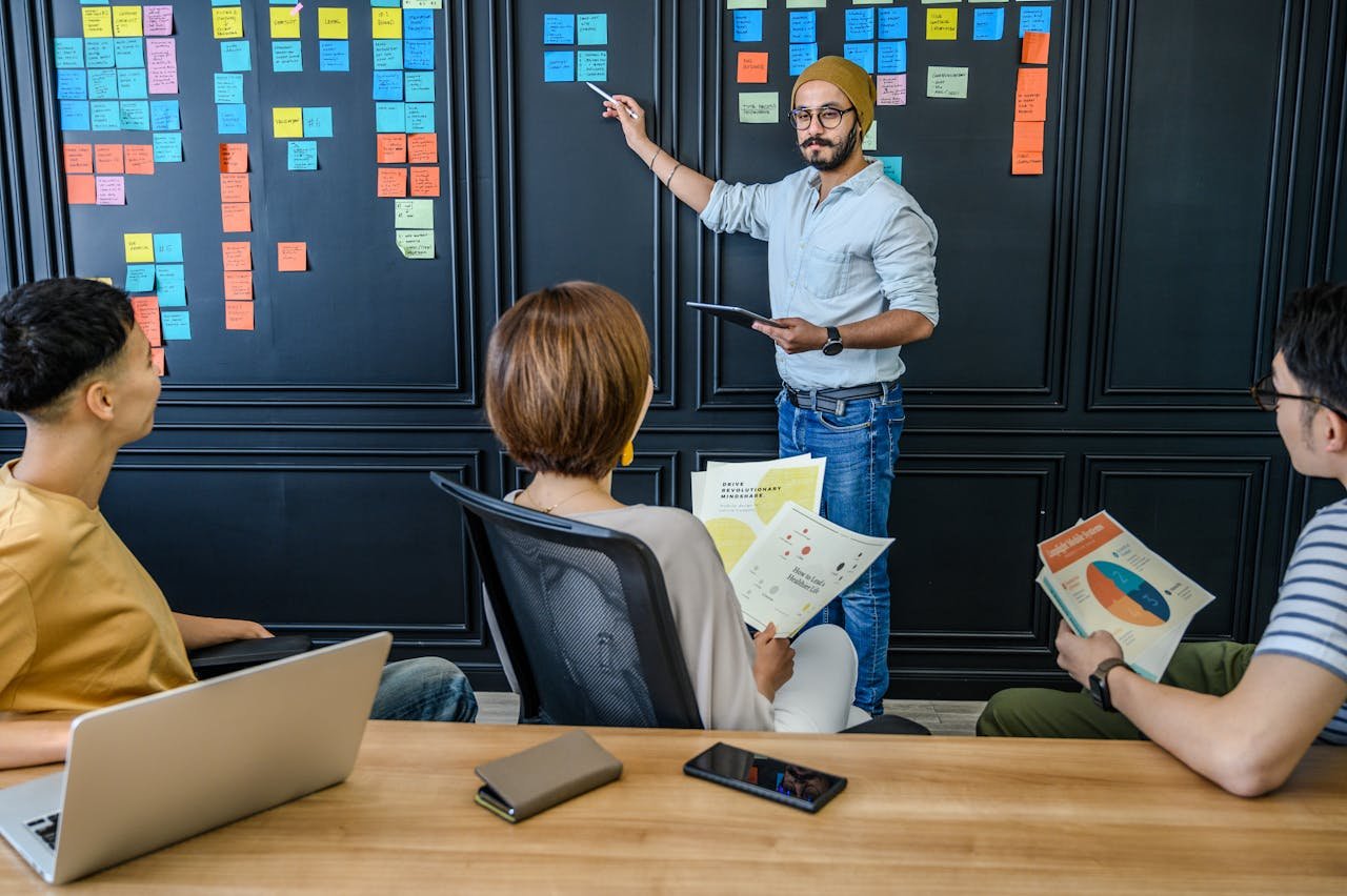 a man standing in front of a blackboard with many sticky notes - organic business growth