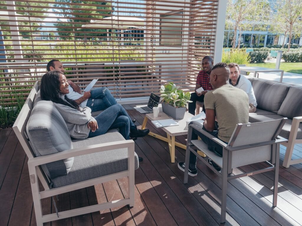 a group of people sitting around a table - Highly Functional Teams