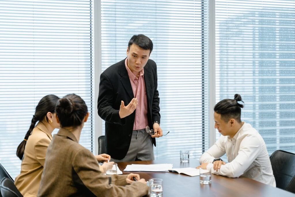 a man standing in front of a group of people - Cross functional role of marketing