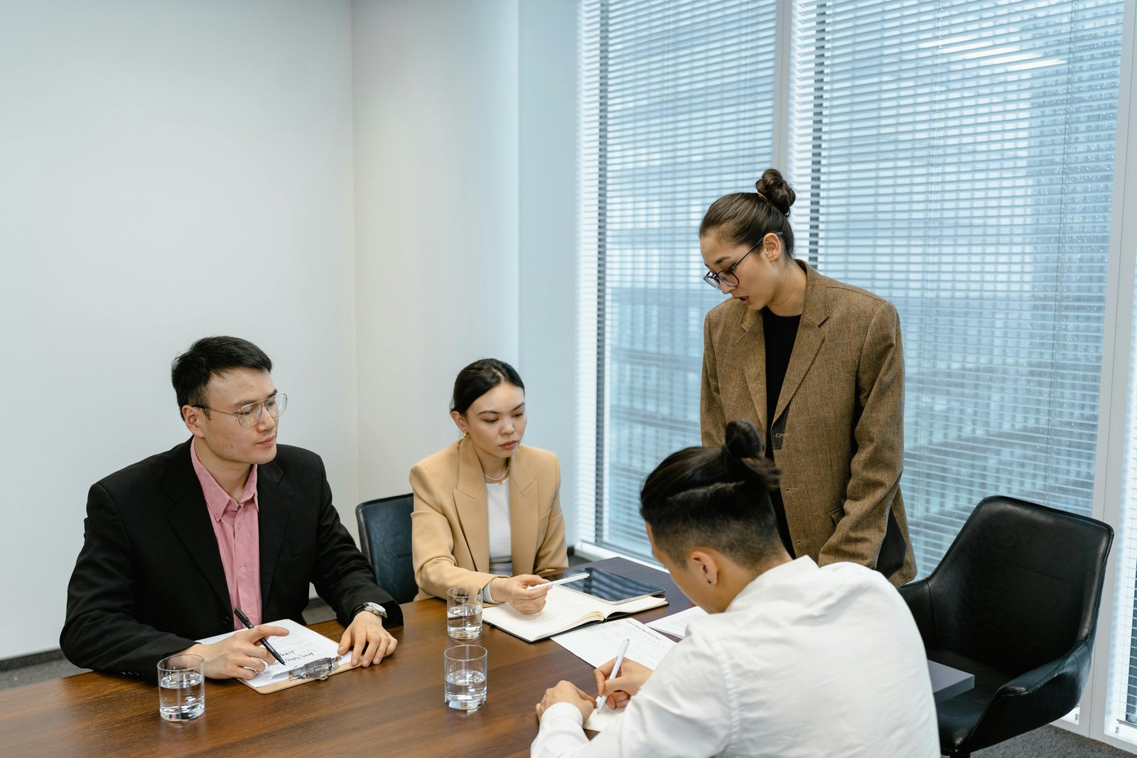 Team members collaborating in a meeting room - Building Cross Functional Teams