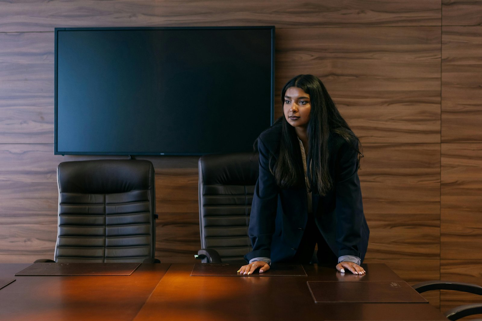 Businesswoman discussing shareholder rights in corporate governance principles meeting room.