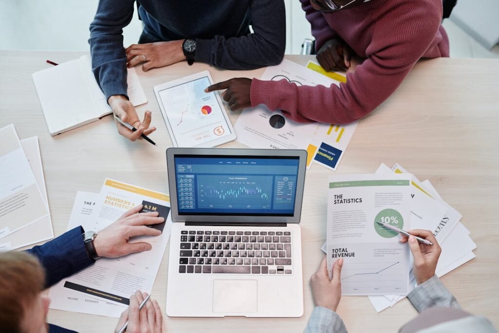 a group of people sitting around a table - Highly Functional Teams