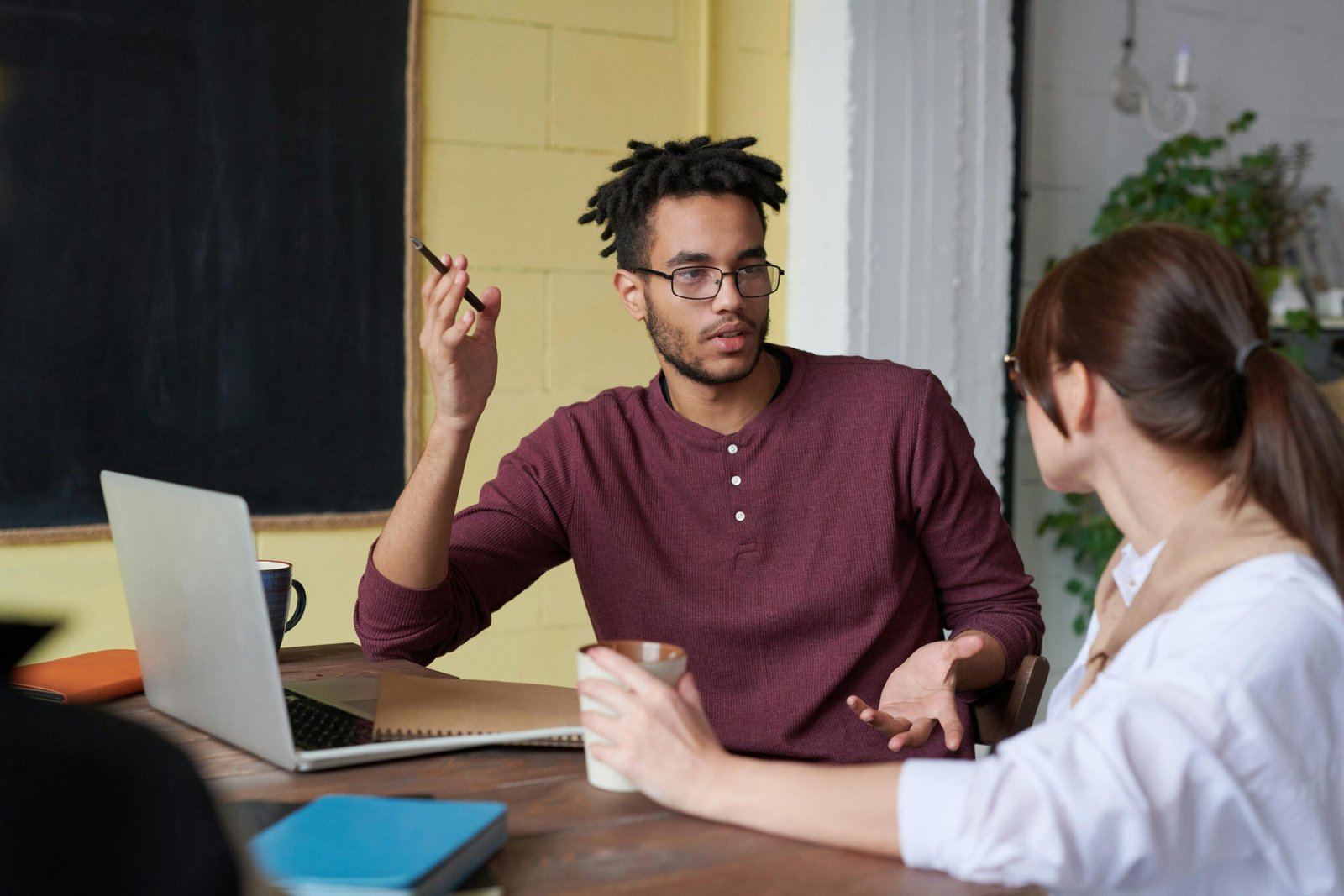 Two colleagues discussing strategies for market penetration during a meeting.