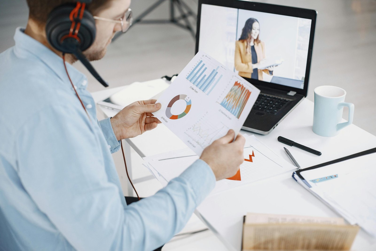 Person reviewing charts during a video conference, analyzing data on Market Size vs Revenue.