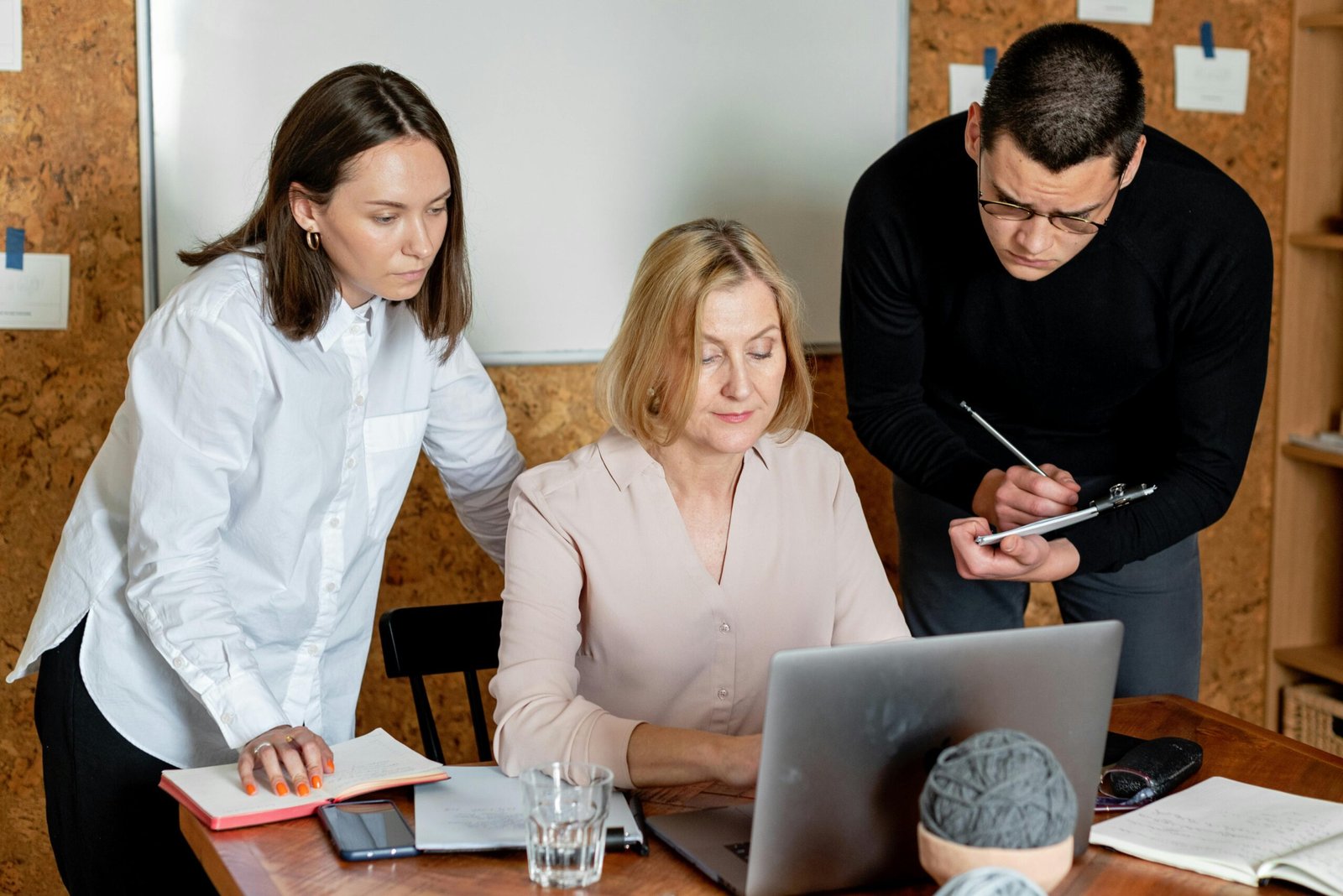 Three colleagues collaborating on a market development strategy.