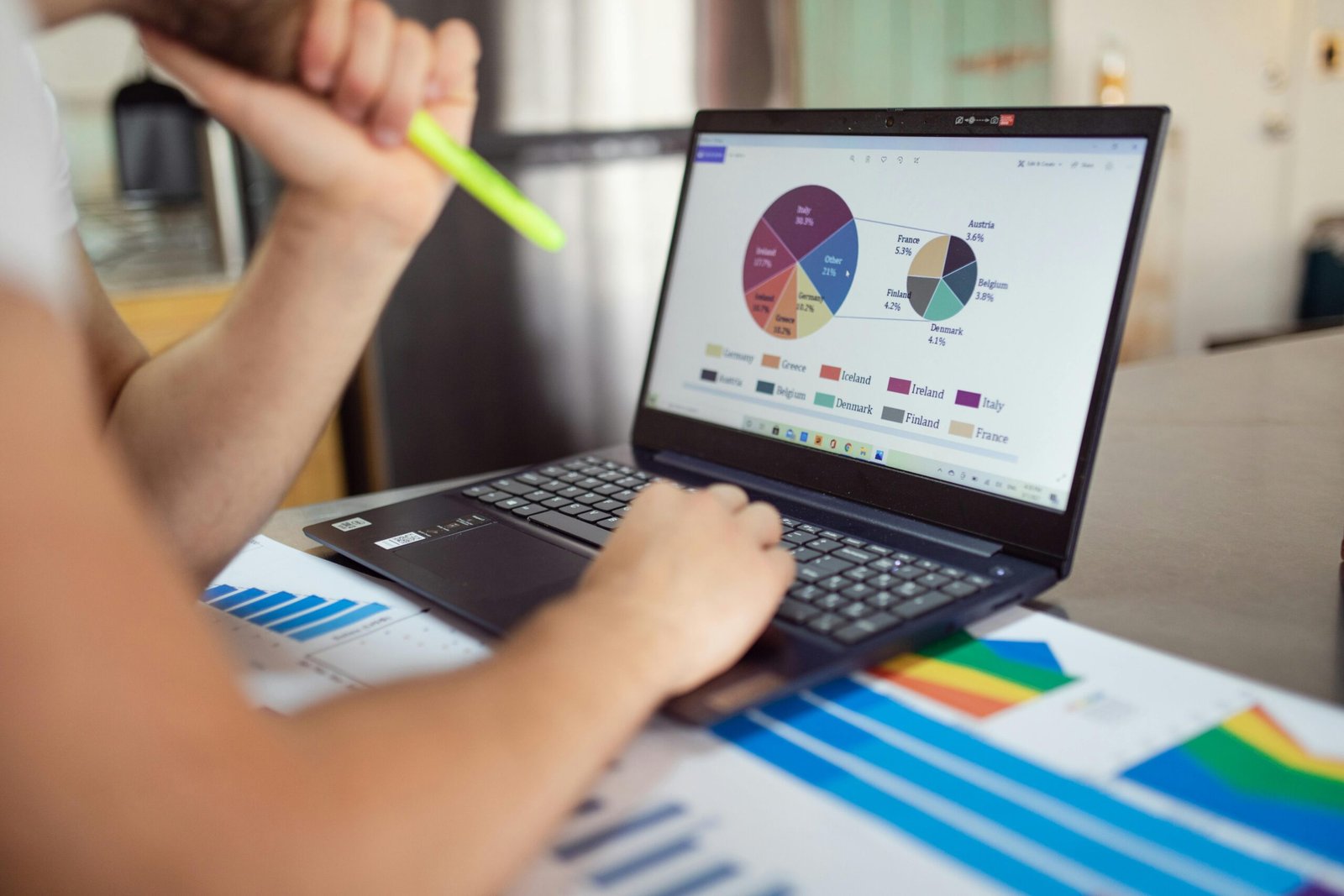 Analyzing charts and graphs on a laptop for 'Market Penetration vs Product Development' insights.