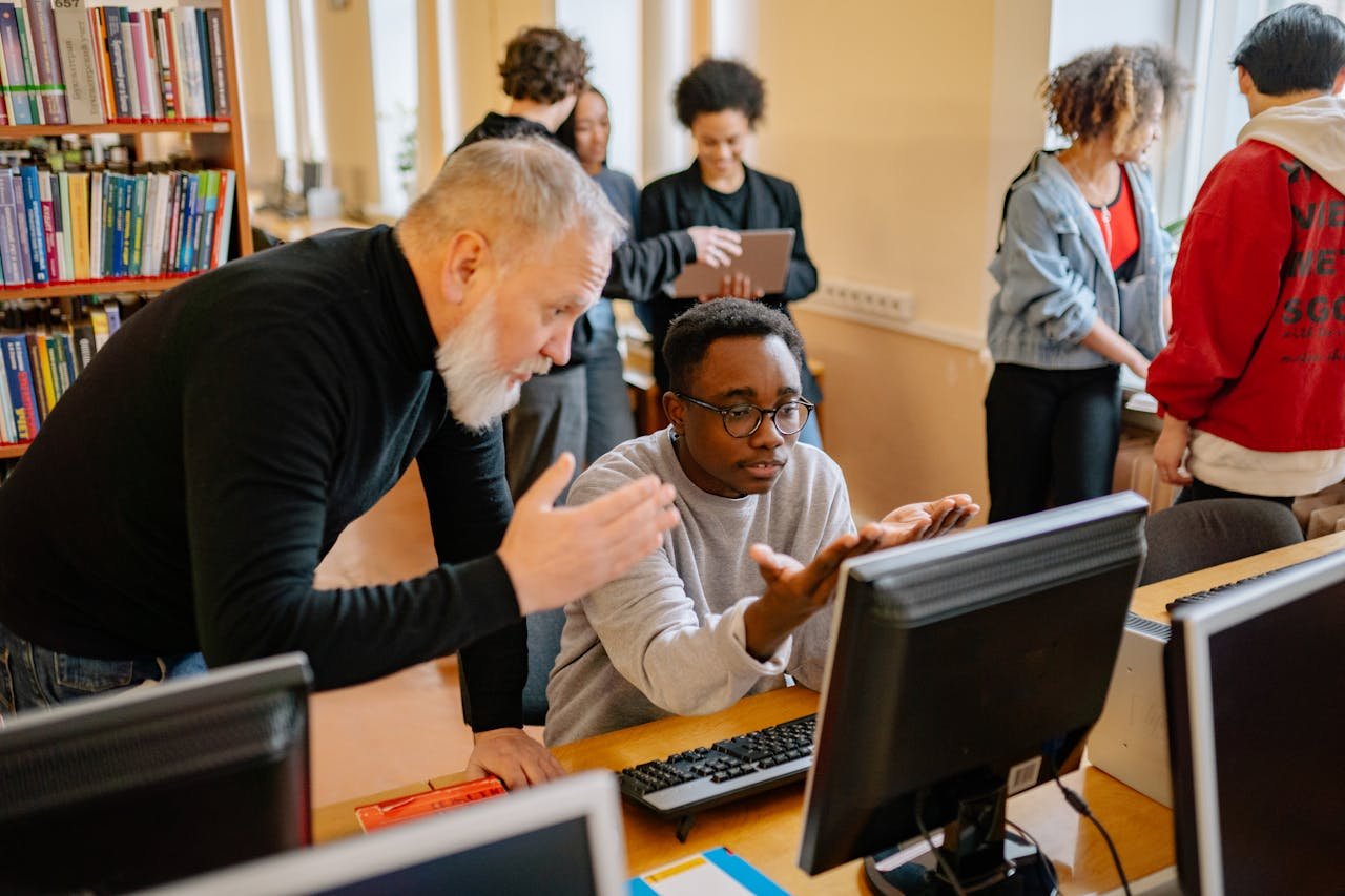 people looking at a screen - What are DEI programs in schools?