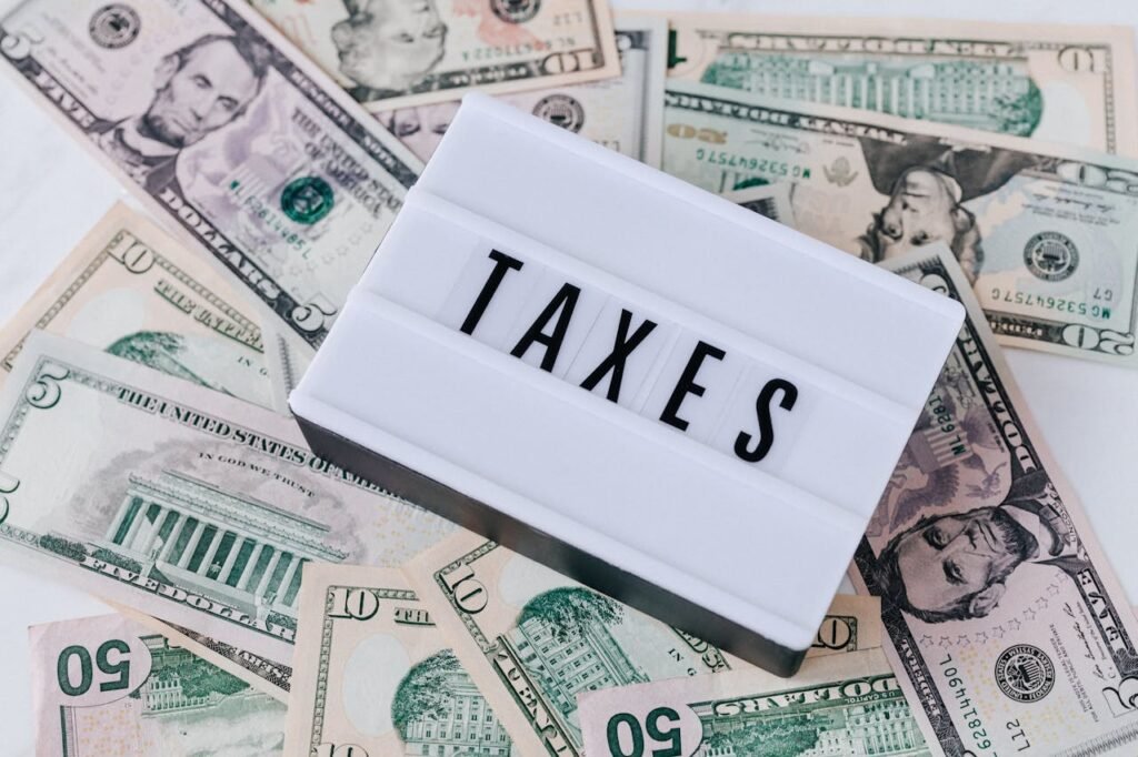 quote board with word taxes on top of money - tax cuts for small businesses