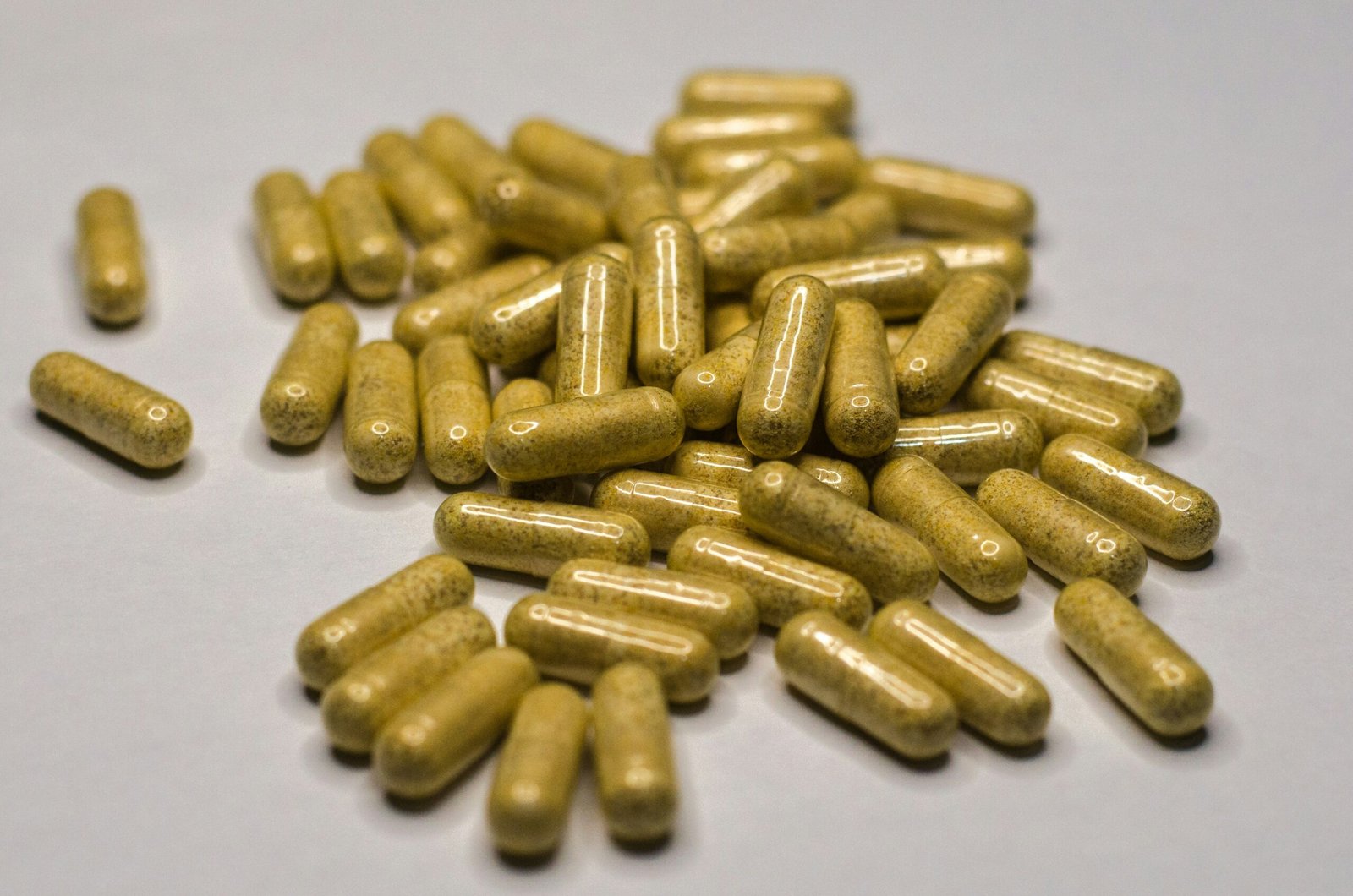 Yellow pills on a white surface