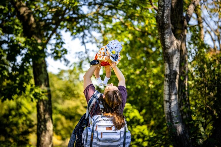 Woman carrying a baby with a diaper backpack
