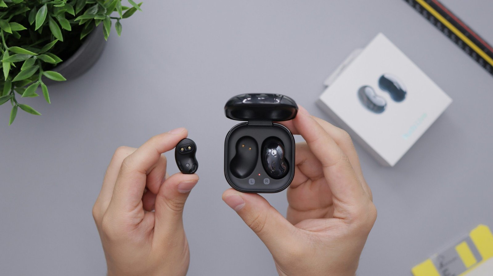 Hand holding earbuds