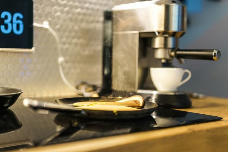 A kitchen countertop with coffee maker and pancakes