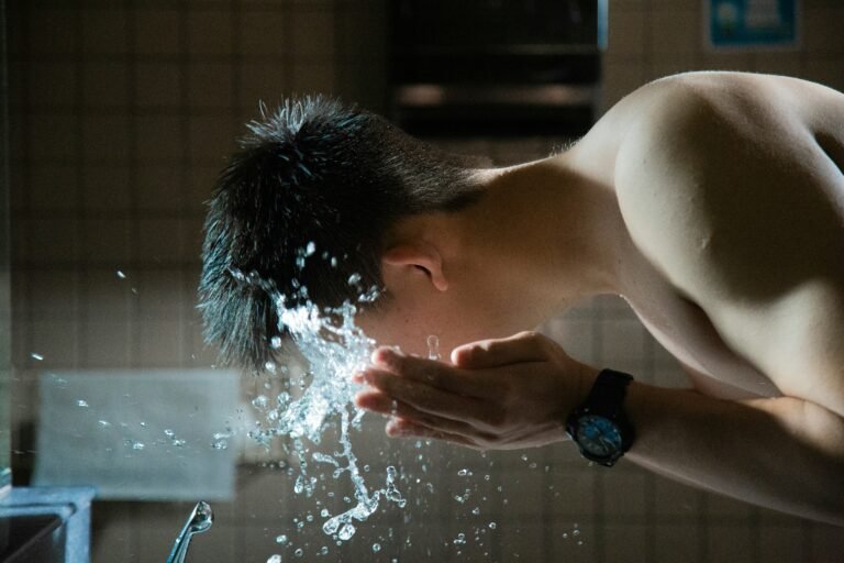 Man washing his face