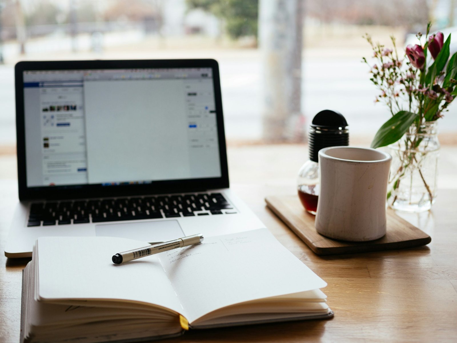 Open laptop and book on a table