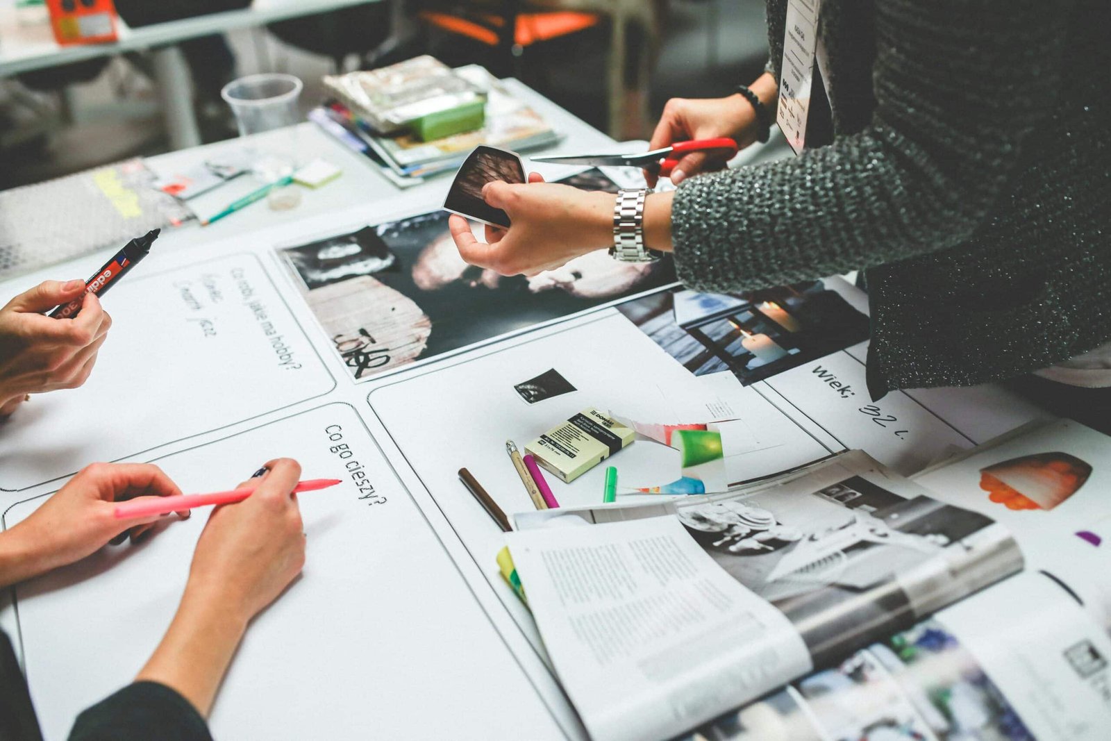 A round-table meeting with graphs and magazines on the table
