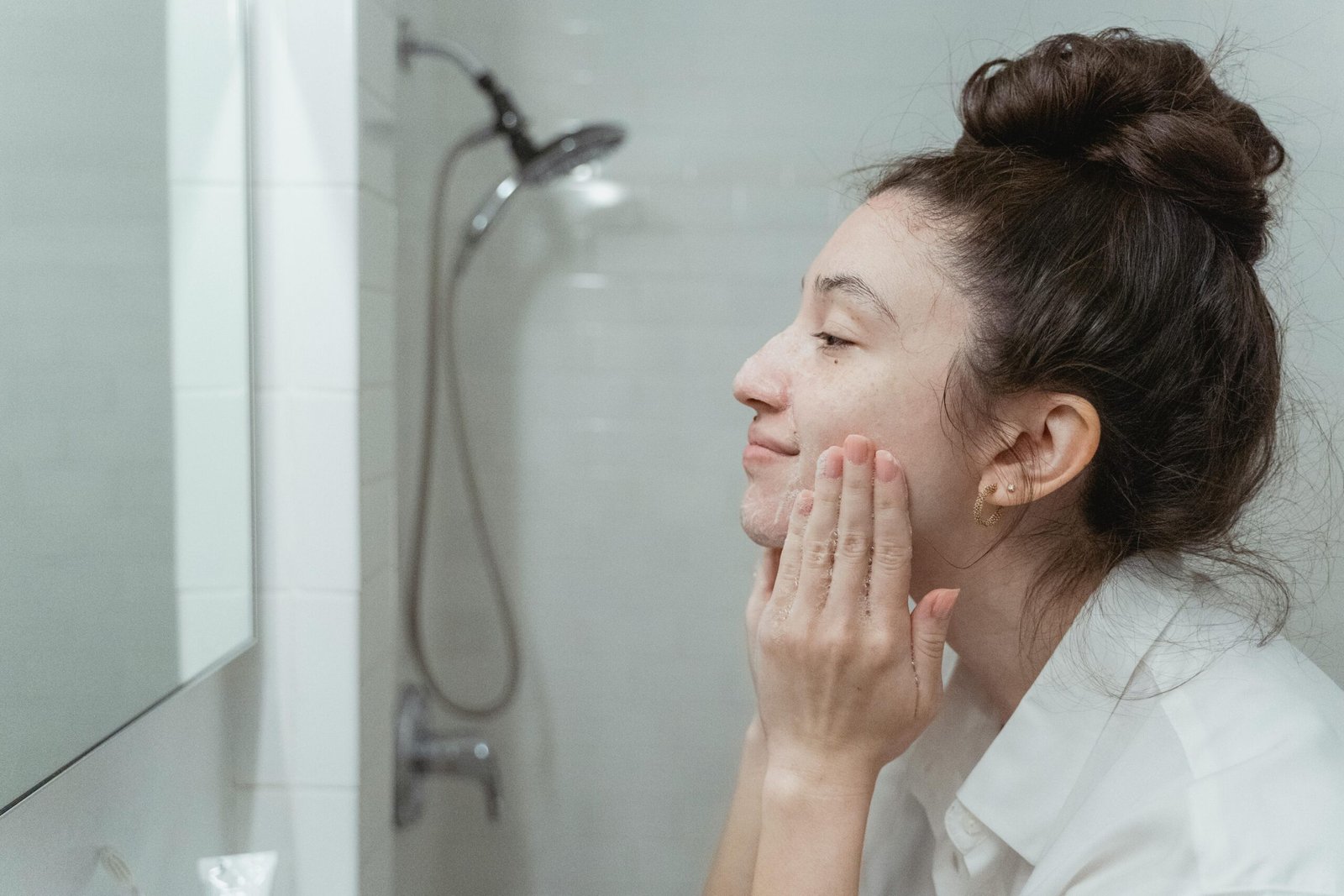 Woman in front of a mirror patting her face